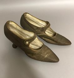 A pair of petite Antique Edwardian Ladies shoes in a bronze metallic fabric with single strap and pearl button closure. Stamped inside John Wanamaker. In original condition as found, without having any restoration done.  Measurements are:  9.5" long 4.75" height  2.25" heel  2 5/8" sole width widest part A great pair of Victorian shoes for display with vintage clothing or in a Victorian home. Extra care will be taken in preparation for shipping this fragile piece. I usually ship in 1-2 business days. Thank you for viewing BelleEpoqueCadeau! Edwardian Shoes, Ankle Lace Up Boots, Historical Shoes, Vintage Shoes Women, Victorian Shoes, Womens Costume, Black Oxford Shoes, Beaded Shoes, Handcrafted Boots