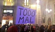 a group of people standing in front of a building with a sign that says too mal