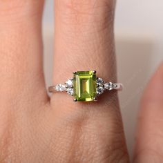 All HANDMADE ITEMS SHIP IN APPROX 8 DAYS Main Stone: Genuine natural peridot Main Stone Size: Emerald cut 6 mm x 8 mm Main Stone Weight: 1.64 carat Side Stone: CZs Height From The Ring Setting Bottom(to gemstone top): about 5.13 mm Width of Ring band Measure: gradually varied,about 1.67 to 1.91 mm Material: .925 Sterling Silver/14K White Gold/14K Yellow Gold/14k Rose Gold Engraved: Available For FreeNo more than 13 letters) Customized:Of course! Tell me what you want Includes With Order: All of Birthstone Wedding Ring, Wedding Ring For Women, August Birthstone, Gold Engraving, Peridot Ring, Ring Setting, August Birth Stone, Ring Band, 8 Days