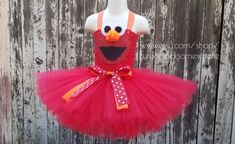 a dress made to look like an elmo bird with polka dots on the bottom