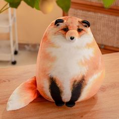 a stuffed animal sitting on top of a wooden table