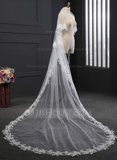 a white wedding veil on display in front of a window