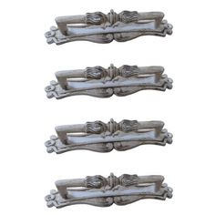 three metal handles with decorative designs on them