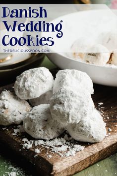 danish wedding cookies on a cutting board with powdered sugar