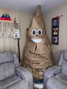 a room with two recliners and a large bag in the shape of a face