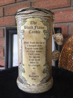 the black flame candle is sitting on a table