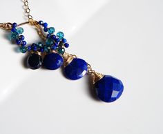 "Lapis lazuli, mystic london blue topaz and sapphire, beautiful navy blue gemstones cluster lariat necklace. They are light weight, will match with pair of jeans or fancy dress. Please a drop through a pandant twice for being stable. All material is 14K gold filled Lapis lazuli drop approx 8, 10mm The length of the pendant is 1.8\" ( 4cm) Chain 18\" or 20\" please select a length Comes in a gift box Matching earrings is available, https://www.etsy.com/listing/493628400/lapis-lazuli-drop-earrings Blue Lariat Necklace For Gift, Blue Lariat Jewelry With Adjustable Chain, Blue Long Drop Necklace As A Gift, Blue Long Drop Necklace As Gift, Blue Long Drop Necklace For Gift, Blue Gemstone Lariat Necklace, Blue Dangle Jewelry With Adjustable Chain, Blue Sterling Silver Lariat Jewelry, Blue Lariat Necklace With Natural Stones