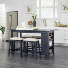 a kitchen with two stools and a table