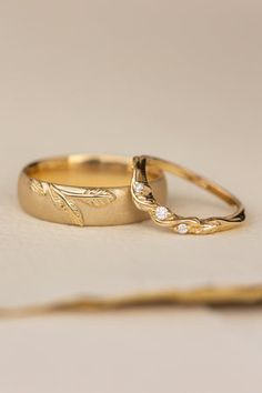 two wedding rings sitting on top of each other