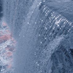 water gushing out from the side of a waterfall