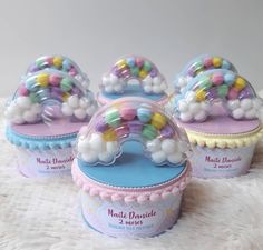 four small round candy tins with multicolored beads on them sitting on a white furnishing