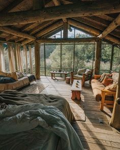 two beds in a room with wooden floors and windows