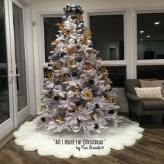 a white christmas tree with black and gold ornaments