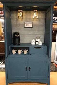 a blue cabinet with two coffee mugs on it