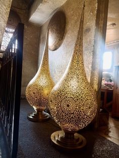 three decorative vases sitting on top of a table next to each other in a room