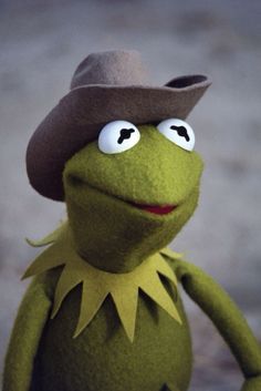 kermie the frog wearing a brown hat