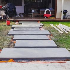 several pieces of concrete laid out in front of a house