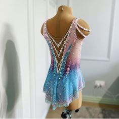 a mannequin wearing a blue and pink dress with sequins on it