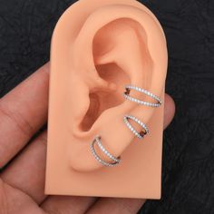 This Features two hoops that join at the top forming a single (double) hoop ring. Double effect, in only one piercing. Very easy to put on and super comfortable. And is embellished with numerous tiny CZ gems that makes the hoop super shiny and Dainty, just what you need to add to your collection Works perfectly in different sizes for several piercing locations: Tragus, Earlobe, Cartilage, Helix, Rook, Daith, Nose, Septum... Made of durable 316L surgical stainless steel, nickel-lead free, and hyp Double Hoop Nose Ring, Piercing Locations, Daith Ring, Hoop Nose Ring, Daith Rings, Nose Septum, Tragus Jewelry, Helix Hoop, Conch Earring