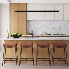 a kitchen with marble counter tops and stools