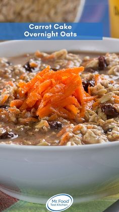 a bowl of oatmeal with carrots and raisins