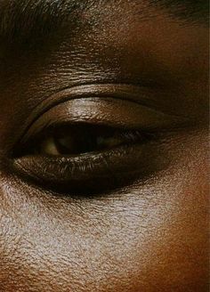 an image of a woman's eye with brown skin