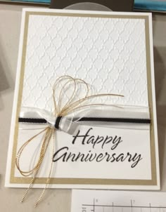 an anniversary card with a ribbon on it