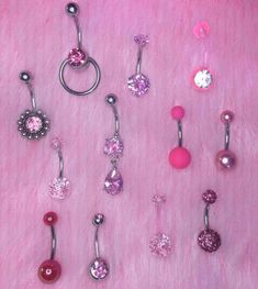 there are many different types of piercings on the pink furnishing, including balls and beads