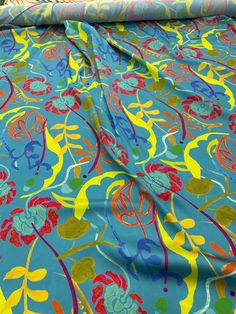 a blue and yellow floral print bed spread