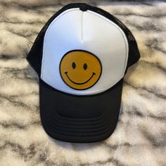 Black & White Smiley Face Trucker Hat Yellow/Gold Smile On Front Mesh/Trucker Adjustable *Never Worn* Black Brimmed Trucker Hat For Spring, Trendy Black Trucker Hat, Beach Black Baseball Cap, Casual Black Trucker Hat For Spring, Black Snapback Trucker Hat For Spring, Trendy Black Brimmed Baseball Cap, Black Trucker Hat For Spring Beach, Spring Beach Black Trucker Hat, Fun Black Trucker Hat With Curved Brim