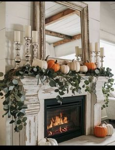 Your fireplace is the perfect focal point for cozy fall decor. Dress up your mantel with seasonal touches like garlands made of faux leaves, pumpkins, and dried flowers. Add height with candlesticks or lanterns, and bring in natural textures like woven baskets or wooden crates to create a layered, rustic look. Consider adding a wreath made of fall foliage above the mantel to complete the ensemble. For extra warmth, display a cozy throw blanket draped over the hearth. This simple yet effective styling will make your fireplace the heart of your fall home. Seasonal Fireplace Decor, Autumn Mantel Decor, Pumpkin Mantle, Fall Mantle Ideas, Cottage Fall Decor, Fall Fireplace Mantel