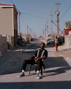 a man sitting in a chair on the street