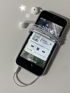 an iphone with ear buds attached to it