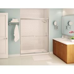 a bathroom with blue walls and white tile flooring, including a walk in shower