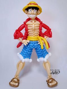 a balloon man is wearing a fireman's hat and blue shorts, holding a yellow rope