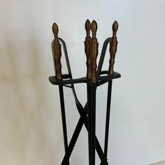 an iron and wood stand with three candles on it