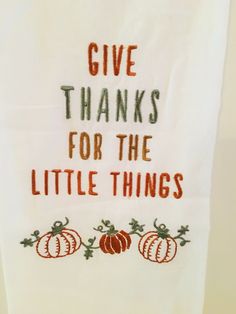 a kitchen towel that says give thanks for the little things with pumpkins on it