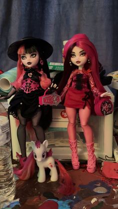 two dolls that are sitting next to each other