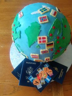 a cake that is sitting on top of a table with some cards and passport around it