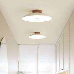 a bathroom with two round lights above the sink