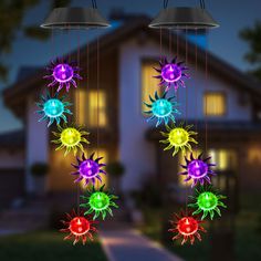 colorful lights hanging from the side of a house