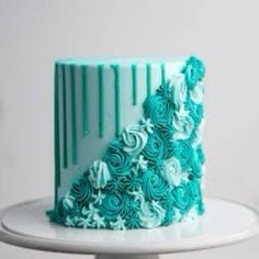 a cake with blue frosting and flowers on it