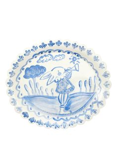 a blue and white plate with an image of a person on a surfboard in the water