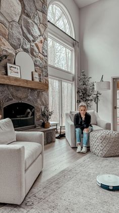 a young boy sitting on a couch in a living room