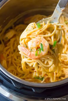 a fork full of pasta with shrimp and parsley in an instant pressure cooker