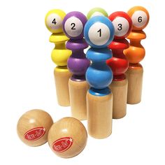 an assortment of colorful wooden balls and numbers on top of each other in front of a white background