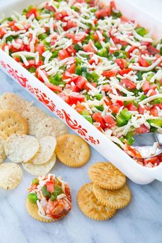 a casserole dish filled with vegetables and crackers