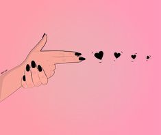 a woman's hand with black nails pointing to hearts on pink background, in the shape of an arrow