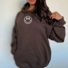 Lightning Bolt Smiley Face Retro Aesthetic Hoodie – Urban Palette Designs Trendy Brown Crew Neck Hoodie, Trendy Brown Hoodie, Trendy Brown Long Sleeve Hoodie, Trendy Brown Hoodie Sweatshirt, Smiley Face Hoodie Aesthetic, Fall Smiley Face Sweatshirt For Streetwear, Trendy Oversized Brown Hoodie, Trendy Relaxed Fit Sweatshirt With Smiley Face, Smiley Face Lightning Bolt Eyes