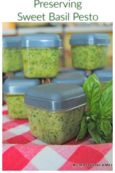 several small containers filled with pesto sitting on top of a checkered table cloth